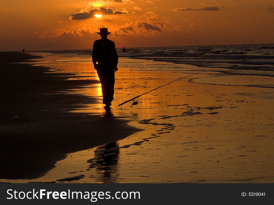 A shot of fisherman walking away from his fishing pole. A shot of fisherman walking away from his fishing pole.