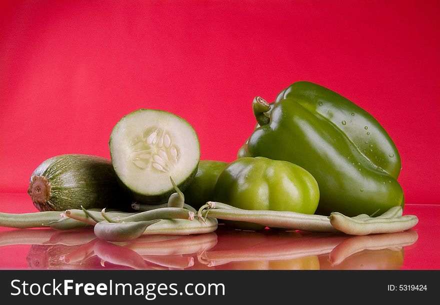 Some green vegetables in a red background