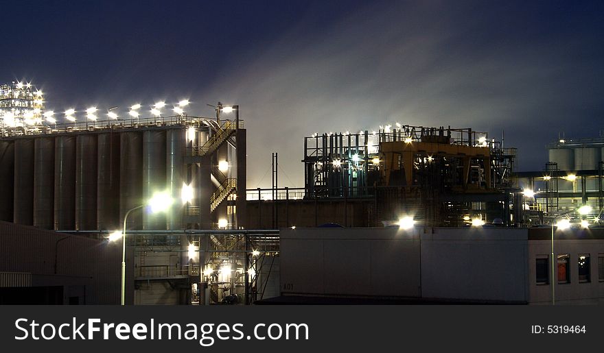 Illuminated refinery at twilight hour