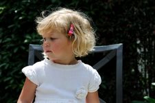 Girl Sitting In Garden Chair Royalty Free Stock Photography