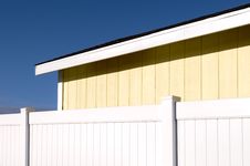 Yellow Building And White Fence Royalty Free Stock Images