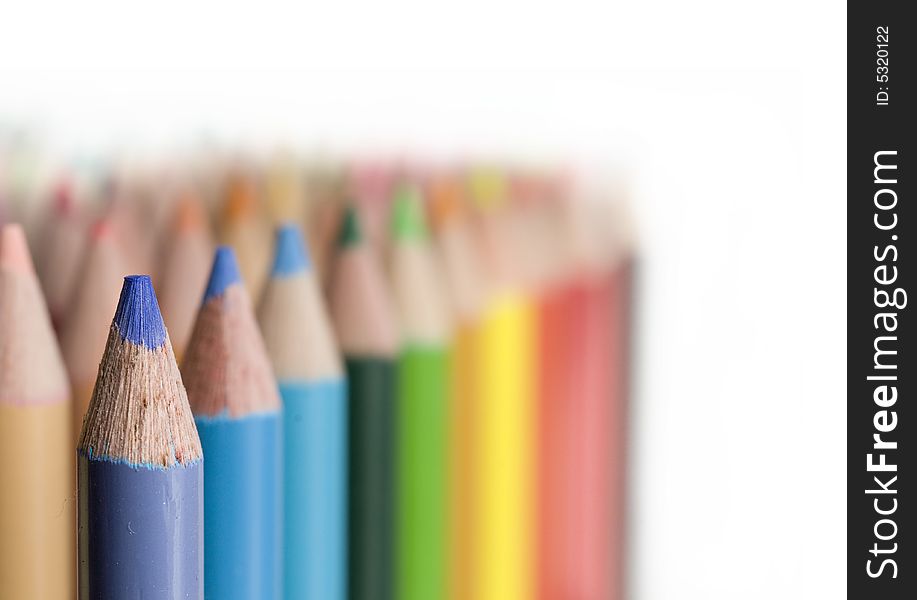 Rows of Bright colored pencils against white background