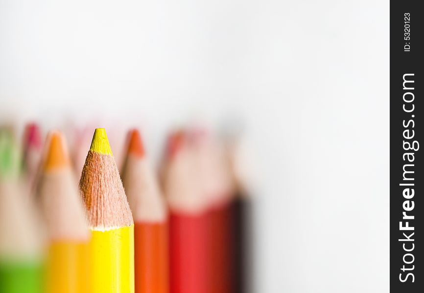 Rows of Bright colored pencils against white background