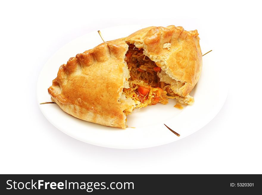 A peeled chicken puff on a plate over white background.