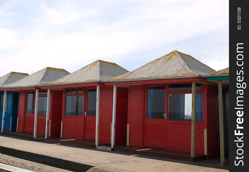 A row of red beach huts