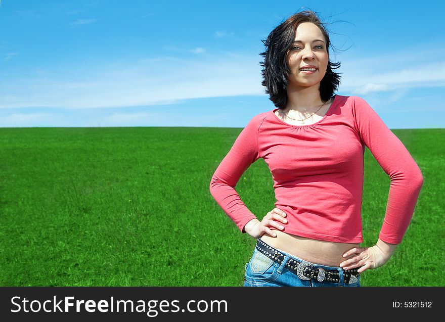 Woman in field with blue sky and clouds