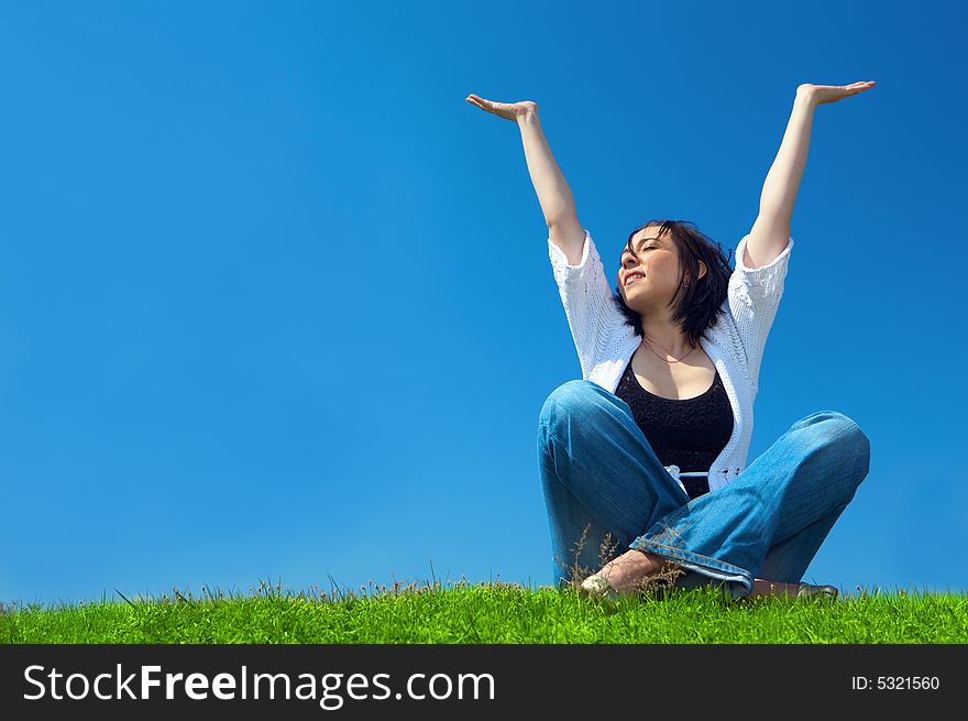 Woman in field hold hand palm up under blue sky and clouds