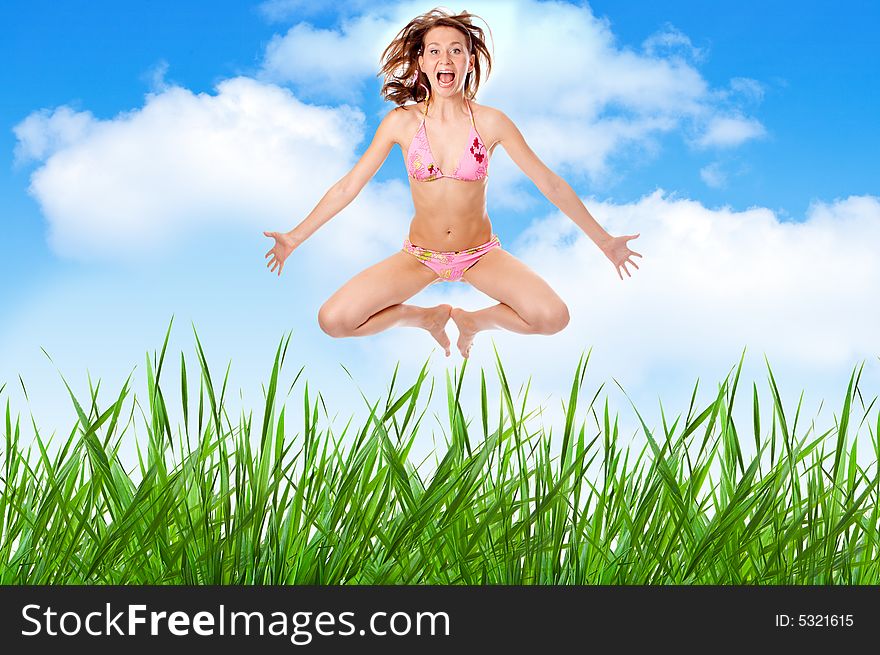 Woman in lingerie jump over grass