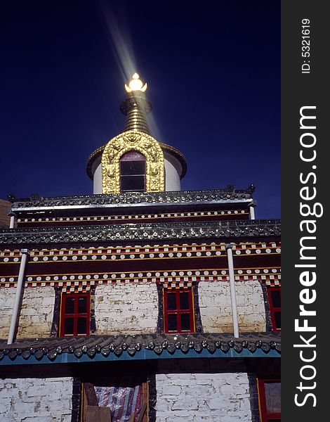 Shining golden pagoda with wonderful craftsmanship in pure dark background