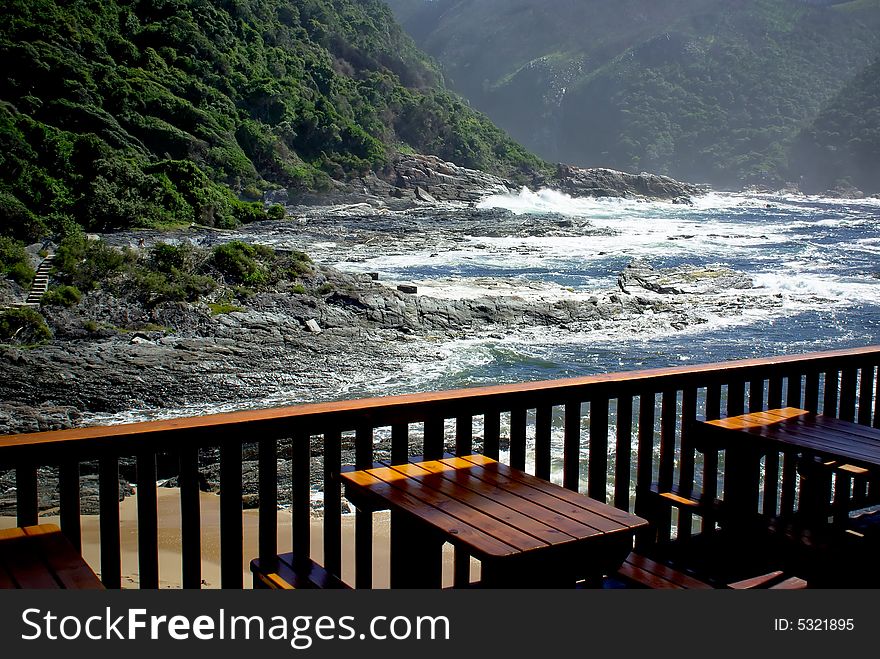 Outdoor cafe near stormy ocean beach in national park of south africa