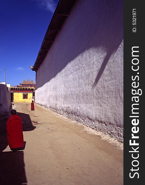 Houses of the monks in a lama temple, sichuan, china. lamas like to brush their walls white and the doors red. Houses of the monks in a lama temple, sichuan, china. lamas like to brush their walls white and the doors red.