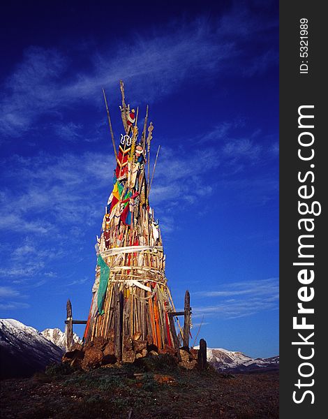 Pole of prayer flags on the top of mountain against blue sky, shot in  gansu, china