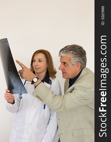 Doctors discussing a radiography of a patient. Doctors discussing a radiography of a patient