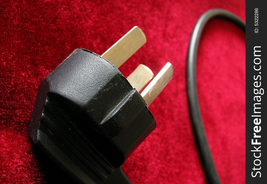 Black plug isolated on  red