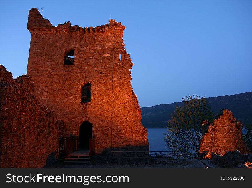 The ruins of the castle at Urquhart at night near Inverness on the banks of Loch Ness in Scotland. The ruins of the castle at Urquhart at night near Inverness on the banks of Loch Ness in Scotland