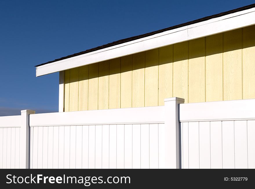 Yellow Building And White Fence