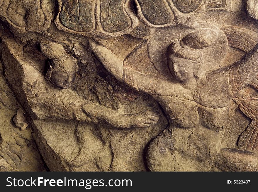 Dancing buddhas carved on rock. Dancing buddhas carved on rock