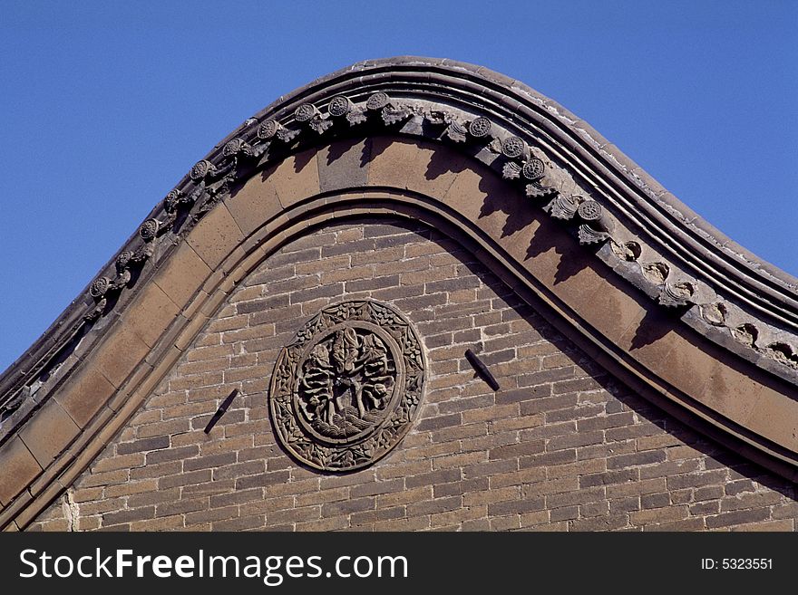 Traditional chinese arched wall with brick carvings as docorations. high arched walls was used to prevent fire. Traditional chinese arched wall with brick carvings as docorations. high arched walls was used to prevent fire.