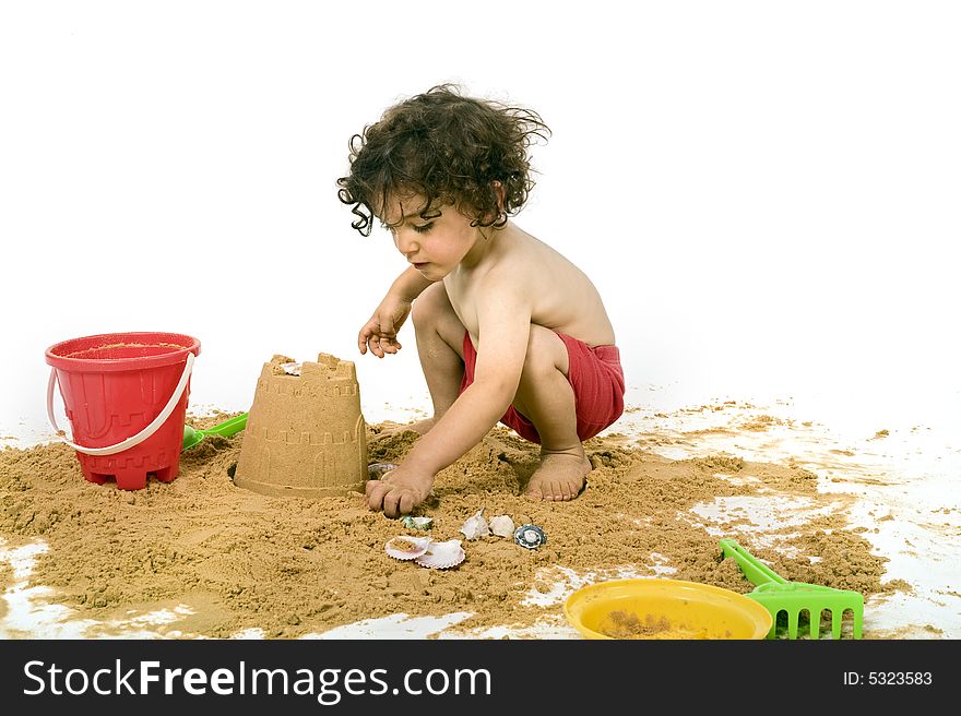 Boy playing in the sand isolated on white