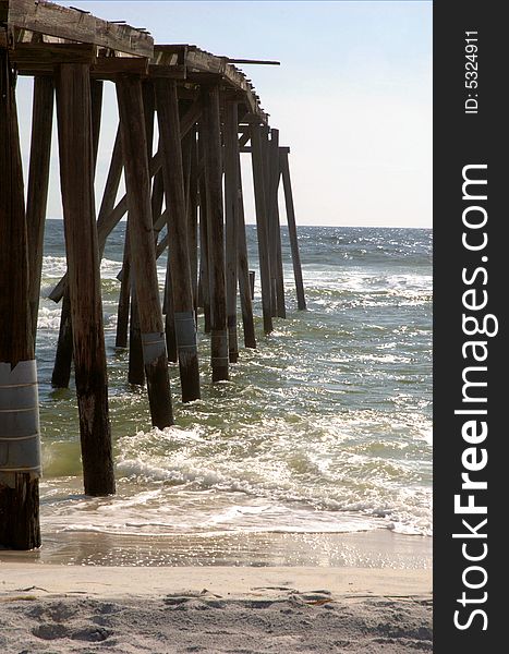 Broken, old pier extends into the Gulf of Mexico from the Florida panhandle coast.