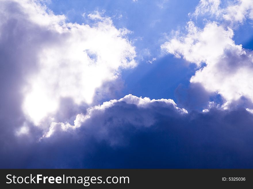 An blue sky filled with dark clouds. An blue sky filled with dark clouds.