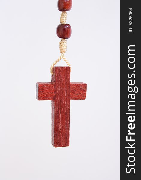 Small wooden cross on white back ground. Small wooden cross on white back ground