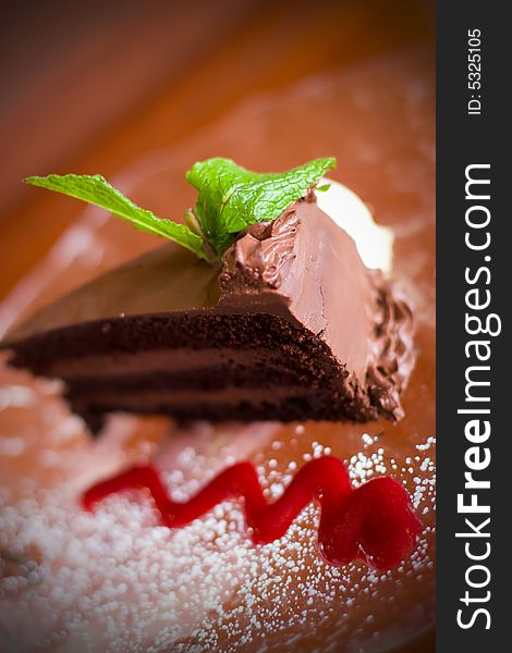 Slice of delicious chocolate cake with a mint garnish