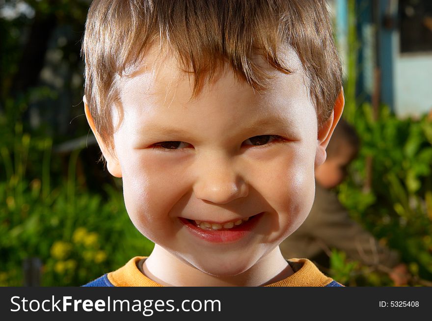 The child close up on a summer background. The child close up on a summer background