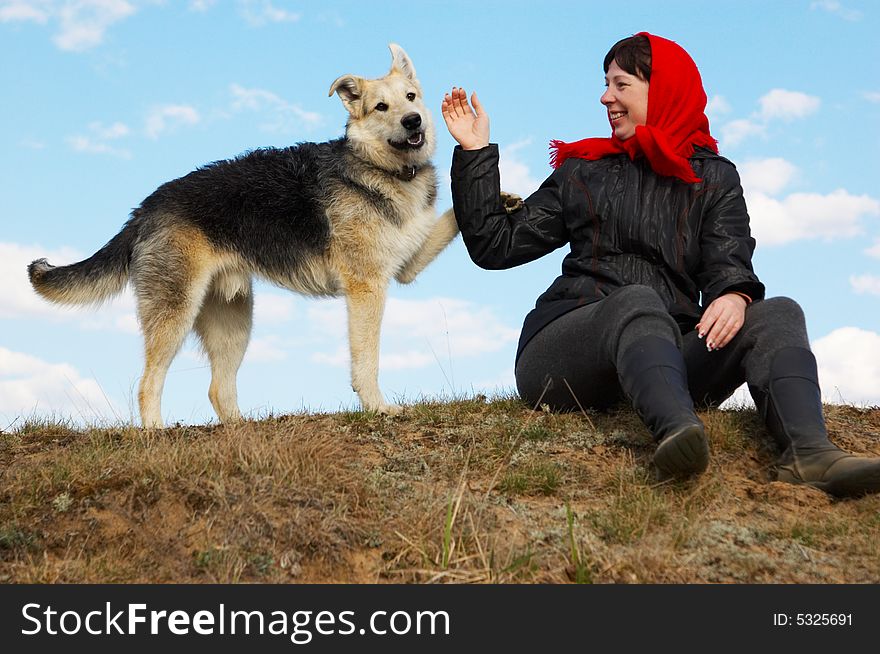 The woman and dog against the sky