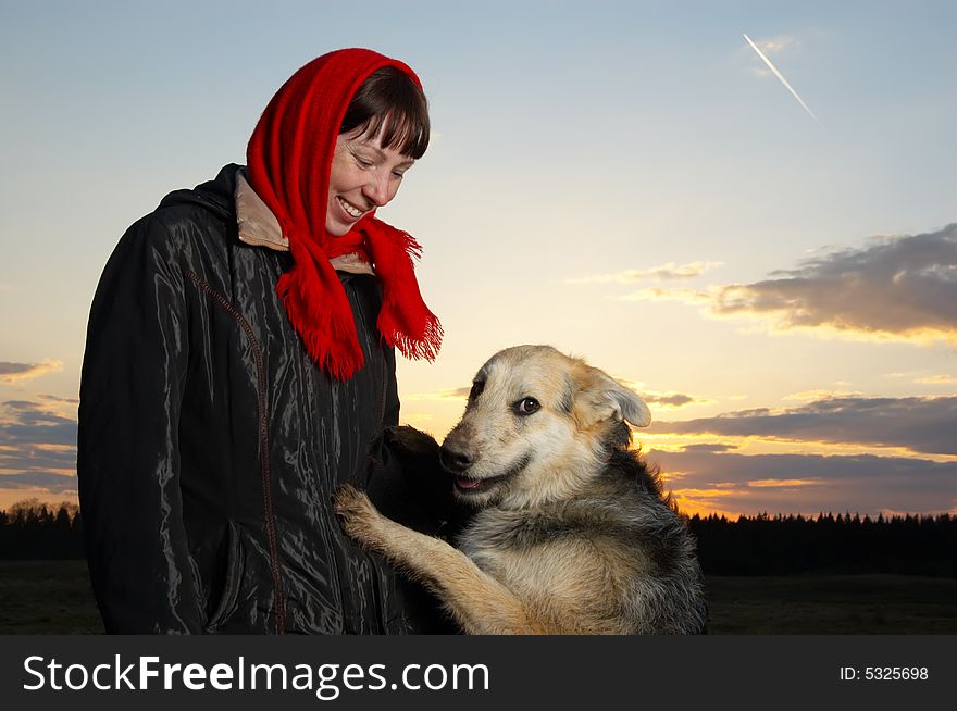 The woman and dog against the sky