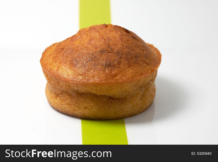 A carrot muffin in a white and green plate