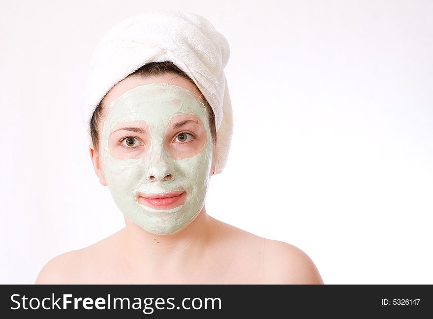 Woman with green mask on her face healthy treatment