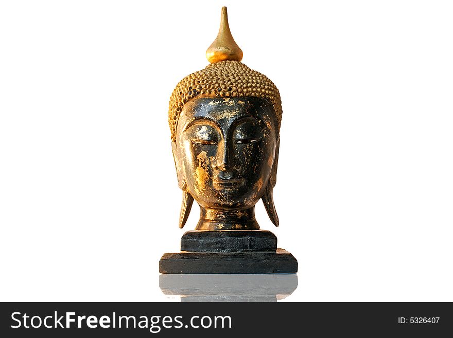 A sculpture of the head of Buddha made in wood. Isolated on a white background. A sculpture of the head of Buddha made in wood. Isolated on a white background