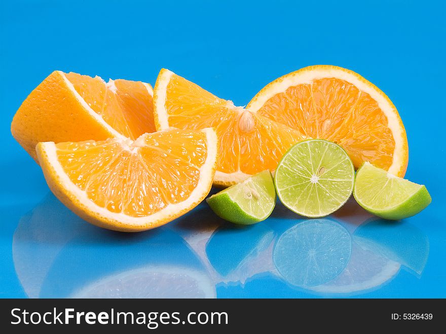 Fresh and juicy oranges and lemons in blue background. Fresh and juicy oranges and lemons in blue background