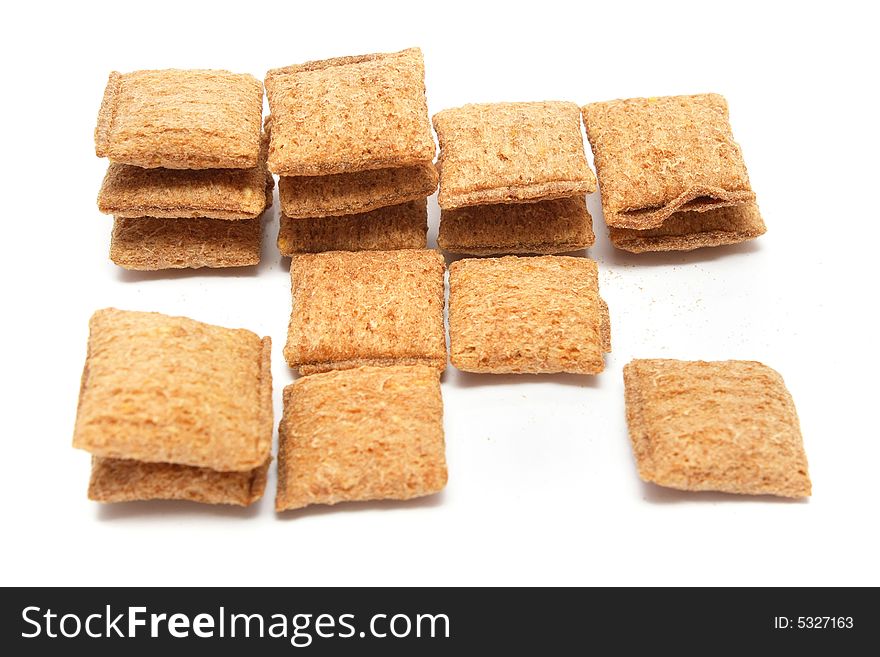 A stack of cereal puff with chocolatey centre over white background.