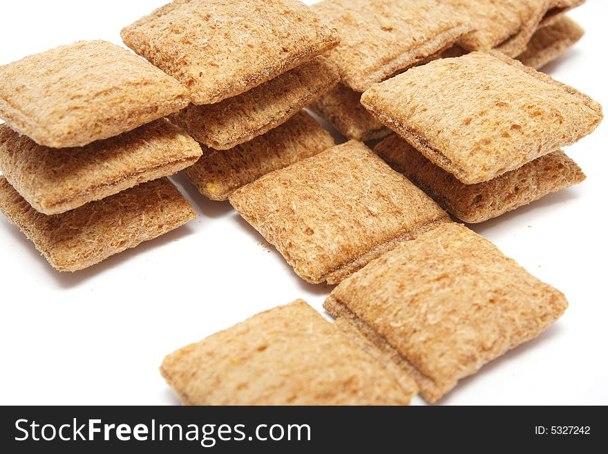 A stack of cereal puff with chocolatey centre over white background.