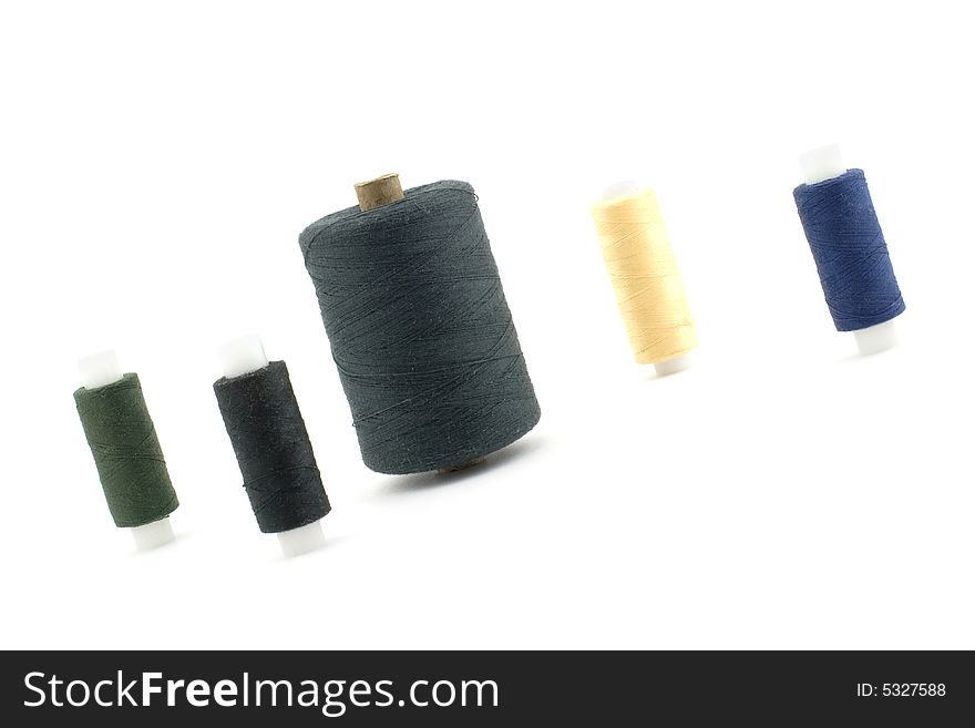 Isolated photo of some reels of threads