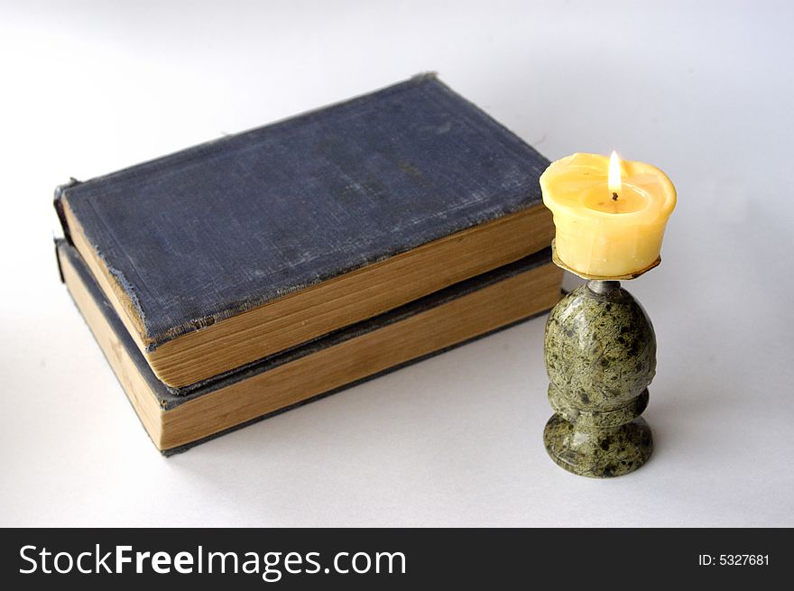Old books with light candle. Old books with light candle