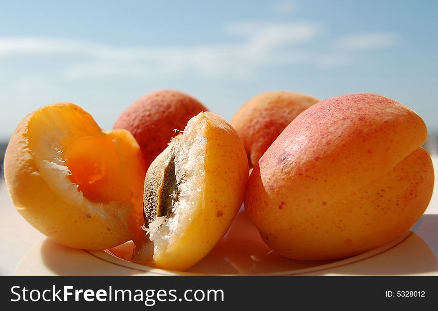 Apricot fruits on the sky background. Apricot fruits on the sky background