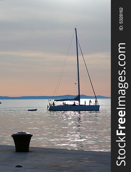 Silhouette of yacht coming into harbour. Silhouette of yacht coming into harbour