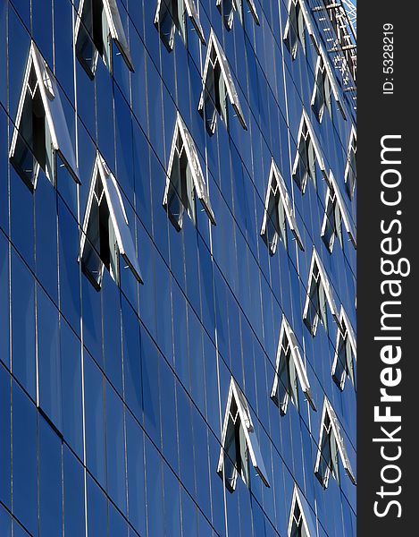 Modern skyscraper windows, reflection pattern, close-up