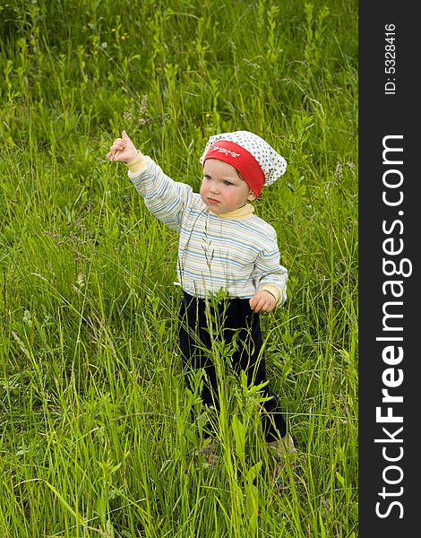 An image of a baby in green meadow. An image of a baby in green meadow