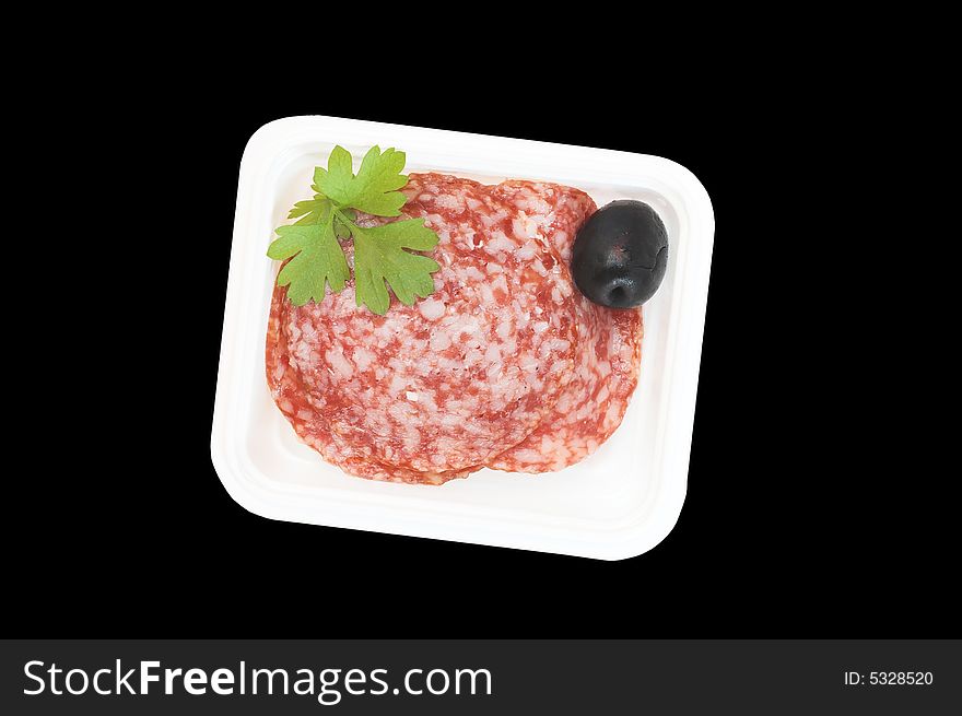 Sliced salami in a plastic container, a part of breakfast in a plane, isolated on black. Sliced salami in a plastic container, a part of breakfast in a plane, isolated on black.