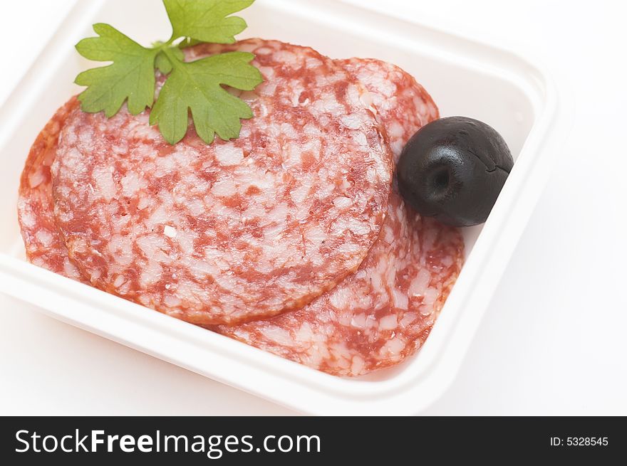 Sliced salami in a plastic container, a part of breakfast in a plane. Sliced salami in a plastic container, a part of breakfast in a plane.