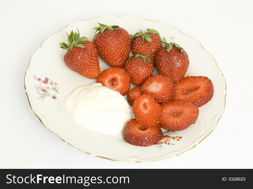 Strawberry with sour cream on a dish