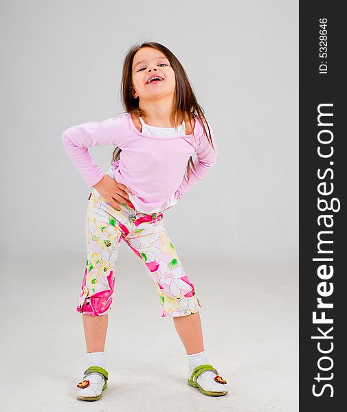 Cute smiling baby girl posing in brightly colored clothes. Cute smiling baby girl posing in brightly colored clothes