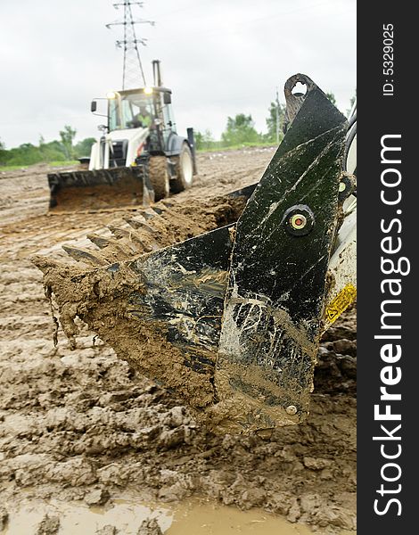 Excavator's bucket in the mud