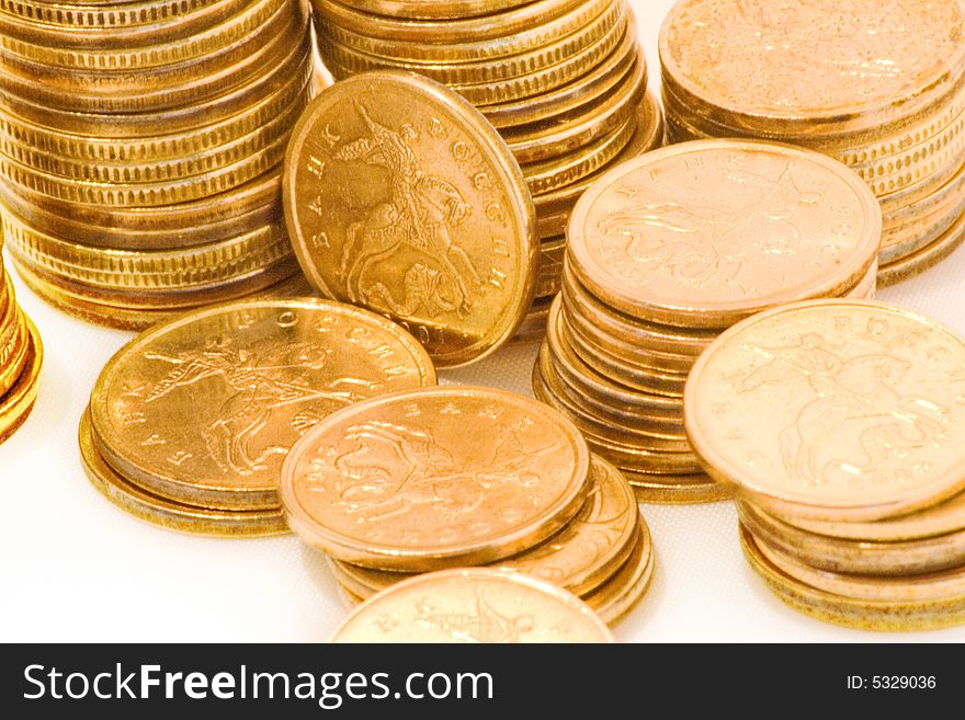 Gold brilliant coins lay on a white background. Gold brilliant coins lay on a white background