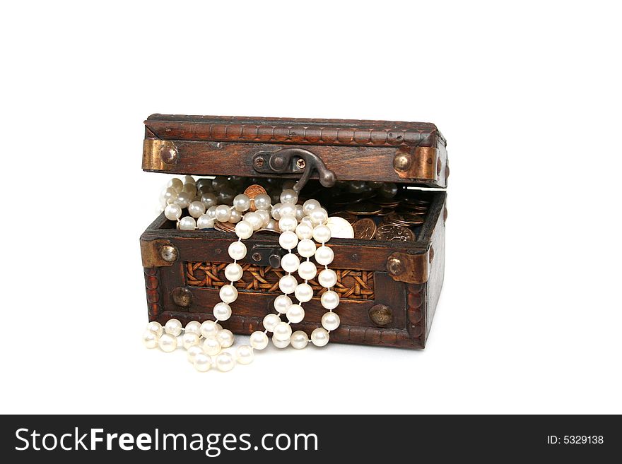 Pearls and coins laying in a wooden chest