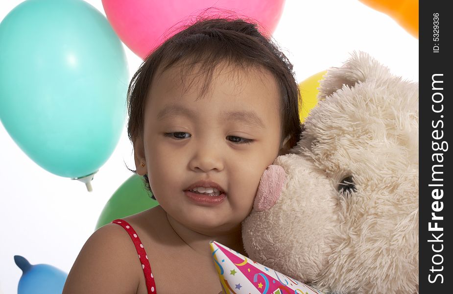 Teddy bear with a child over the balloons